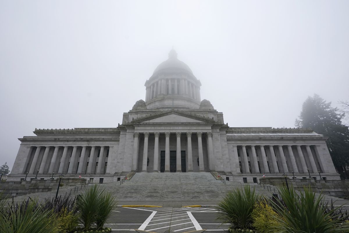 In this Jan. 7, 2021 photo, the Legislative Building is shown partially shrouded in fog at the Capitol in Olympia, Wash.   (Ted S. Warren)