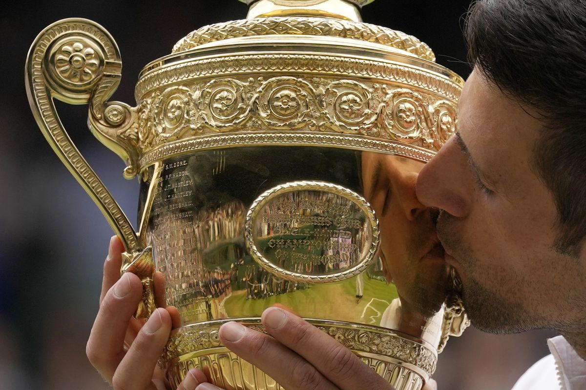 Serbia’s Novak Djokovic kisses the winners trophy after he defeated Italy’s Matteo Berrettini in the men’s singles final of the Wimbledon Tennis on Sunday. (Kirsty Wigglesworth)