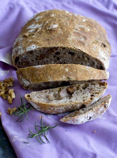 Plan ahead when you make no-knead walnut rosemary bread. It takes little time to mix the dough, but it needs to rise for 12 to 18 hours. (Associated Press)