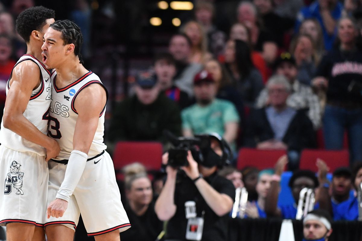 Gonzaga Bulldogs guard Andrew Nembhard, right, reacts after drawing a charge against Memphis on Saturday at the Moda Center in Portland. Gonzaga won the game 82-78.  (Tyler Tjomsland/The Spokesman-Review)