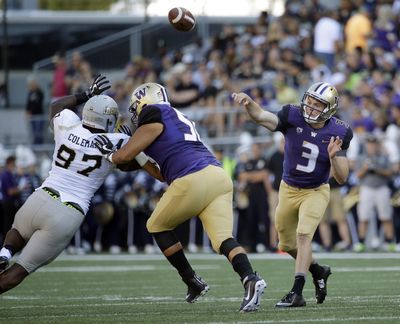 Washington quarterback Jake Browning (3) passes as Idaho defensive end Aikeem Coleman, left, is blocked by Washington offensive lineman Nick Harris, center, in the first half of an NCAA college football game, Saturday, Sept. 10, 2016, in Seattle. (Ted S. Warren / Associated Press)