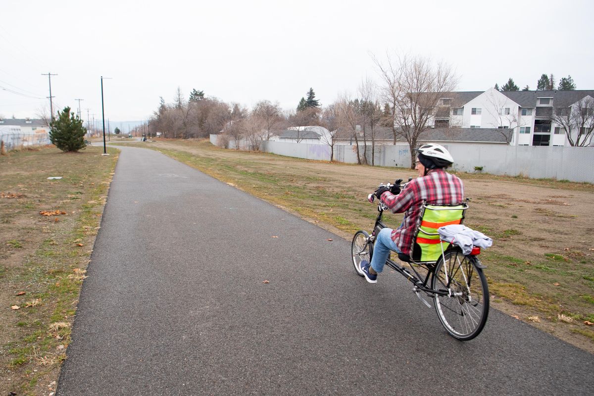 A cyclist rides down the Appleway Trail in Spokane Valley, Monday, Nov. 18, 2019. The trail, a former railroad right-of-way, will soon be completed with the paving of a section from Evergreen to Sullivan. (Jesse Tinsley / The Spokesman-Review)