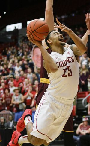 DaVonte Lacy, right, slices to the basket in Cougars’ 74-71 win over Arizona State. (Associated Press)