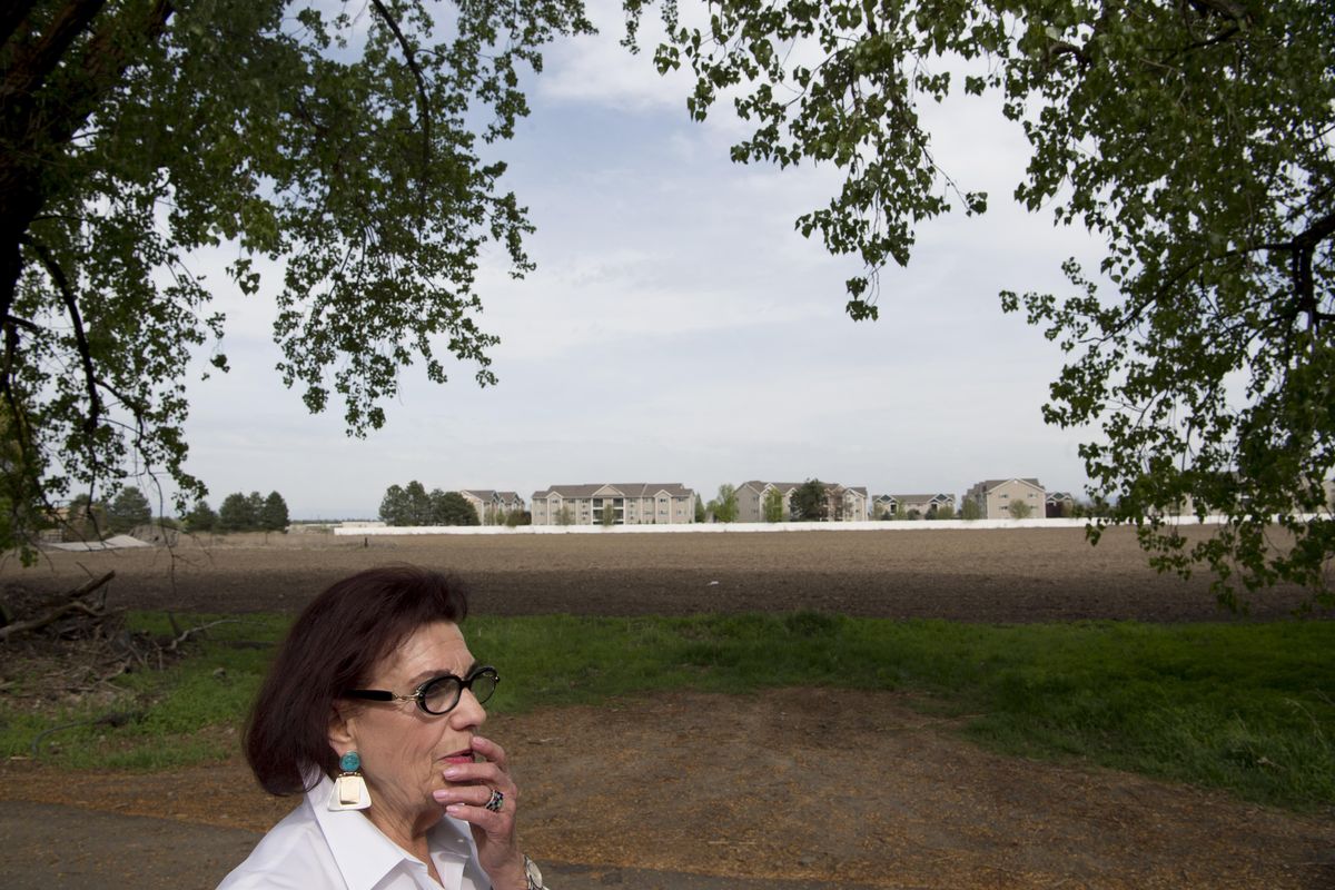 Kitty Archer shows the photographer her land on Thursday, April 21, 2016, in Airway Heights. Archer lives alone in a 1906, 2.5 story farmhouse near Spokane International Airport. The courts have tossed an Airway Heights ordinance that would have allowed Archer to sell her 20 acres to developers to expand an existing arpartment complex, citing future plans of the airport and Fairchild. (Tyler Tjomsland / The Spokesman-Review)