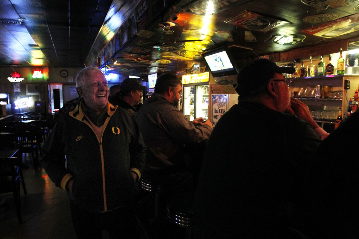 Earle T. Foley, 92, left, laughs with patrons Nov. 12 in the Time Out Tavern he purchased in Springfield, Ore. Most have been coming to the business for years. (Associated Press)