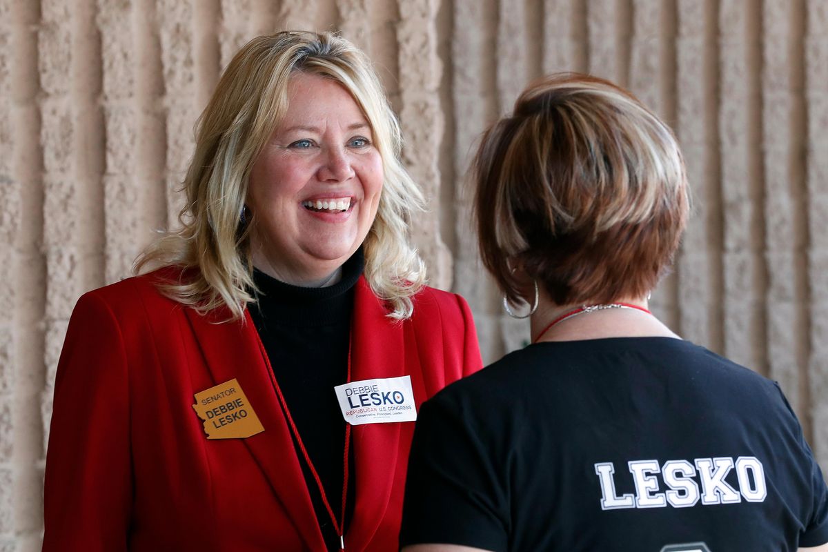 FILE – In this Jan. 27, 2018, file photo, Arizona State Rep. and U.S. Representative candidate Debbie Lesko speaks with a constituent during the meeting of the state committee of the Arizona Republican Party in Phoenix. (Matt York / AP)