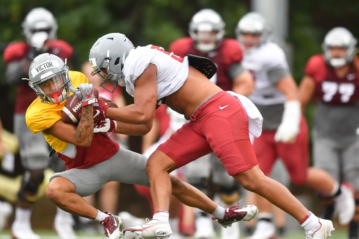 Washington State slot receiver Lincoln Victor fights for the ball during a fall camp practice Tuesday at Rogers Field in Pullman.  (Tyler Tjomsland/The Spokesman-Review)