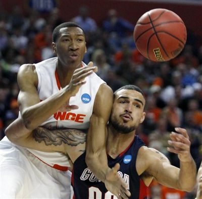 Syracuse's Wes Johnson, left, battles for a rebound with Gonzaga's Robert Sacre during the first half an NCAA second-round college basketball game in Buffalo, N.Y., Sunday, March 21, 2010. (Don Heupel / Fr48438 Ap)