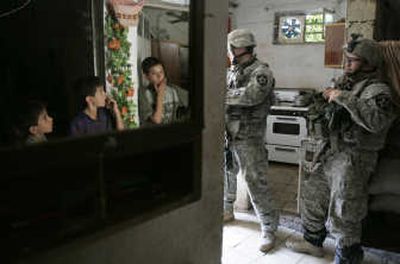 
U.S. soldiers of the 2nd brigade, 12th Infantry Division  search a house during a patrol in the Dora neighborhood in southern Baghdad on Saturday.Associated Press
 (Associated Press / The Spokesman-Review)