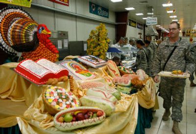 
A U.S. soldier walks past decorations for the Thanksgiving Day celebration at a camp in the fortified Green Zone in Baghdad, Iraq.  
 (Associated Press / The Spokesman-Review)