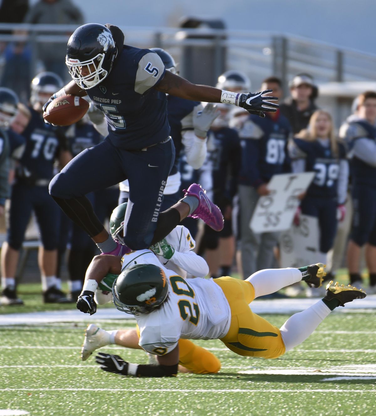 Gonzaga Prep wide receiver Devin Culp jumps over Richland defender Ryan Piper during a State 4A football quarterfinal  at Gonzaga Prep on Nov. 18. (Colin Mulvany / The Spokesman-Review)