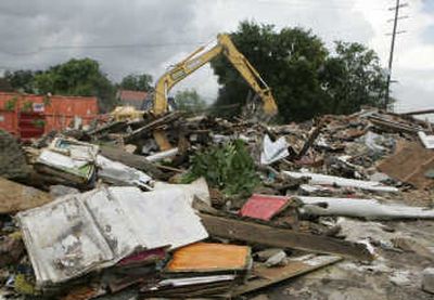 
An excavator works to clear the debris of a hurricane-damaged home in the Lakeview section of New Orleans on WednesdayAssociated Press
 (Associated Press / The Spokesman-Review)