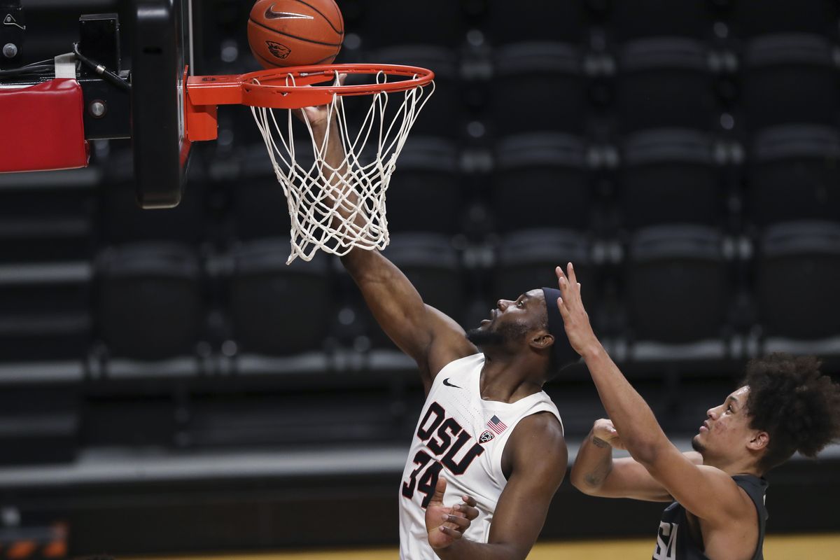 Oregon State's Rodrigue Andela (34) shoots next to Washington State's DJ Rodman during the first half of an NCAA college basketball game in Corvallis, Ore., Saturday, Feb. 6, 2021.  (Associated Press)