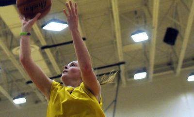 Coeur d’Alene High School junior Amy Warbrick is a standout on the basketball court. She takes a shot during practice at the school on Thursday. (Kathy Plonka / The Spokesman-Review)