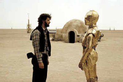 
A young George Lucas talks with Anthony Daniels, who plays the robot C-3PO, on the set for 
