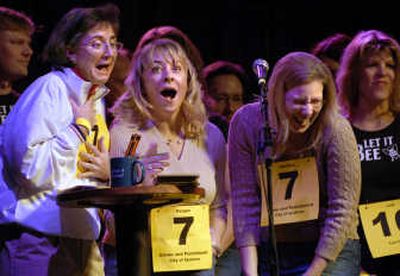 
Spokane Police Chief Anne Kirkpatrick, from left, mayoral assistant Reagan Oliver  and Spokane public affairs officer Marlene Feist  react to missing their first word, 