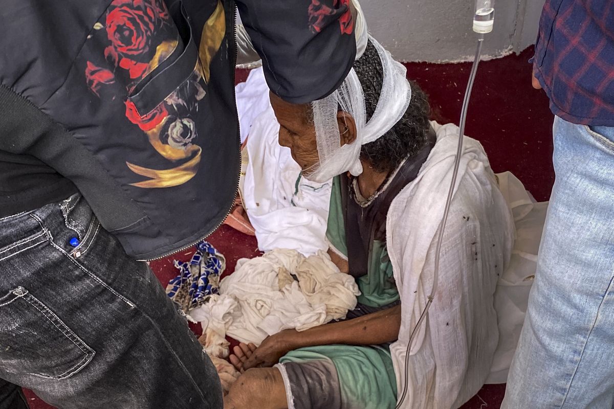 An elderly woman who fled to the city of Axum in the Tigray region of Ethiopia to seek safety sits with her head bandaged after being wounded during an attack on the city, Monday, Nov. 30, 2020. She later died of her wounds. As Ethiopia’s Tigray region slowly resumes telephone service after three months of conflict, witnesses gave The Associated Press a detailed account of what might be its deadliest massacre, at the sacred Ethiopian Orthodox church in Axum.  (HONS)