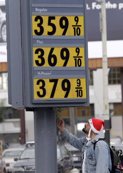 A man studies the gas prices at a Shell gas station in San Francisco earlier this month. Americans are getting a sour holiday surprise at the gas pump, where prices are the highest they’ve been in more than two years.  (Associated Press)