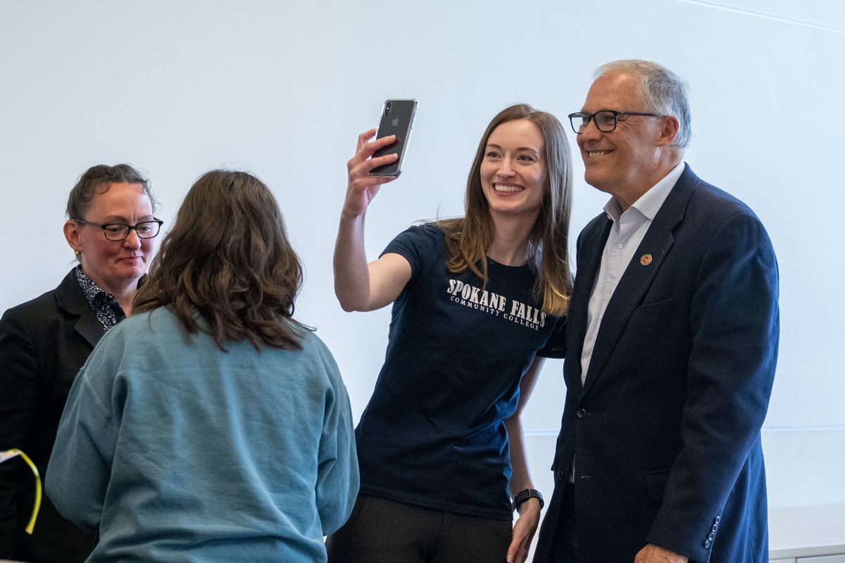 Spokane Falls Community College Environmental Club President Cierra Grove takes a selfie with Gov. Jay Inslee after he did a roundtable discussion with the students, Thursday, April 28, 2022.  (COLIN MULVANY/THE SPOKESMAN-REVI)