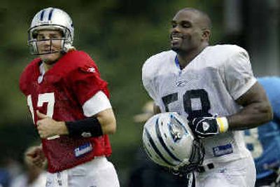 
The joy is evident as Panthers linebacker Mark Fields, right, jogs to a drill with Jake Delhomme Saturday. 
 (Associated Press / The Spokesman-Review)