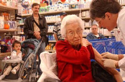 
Ethel Melendy, right, prepares to administer a flu vaccine to Ruth Kurz, 92, at an Albertsons store Friday in Fort Worth, Texas. 
 (Associated Press / The Spokesman-Review)