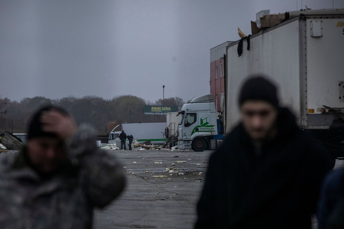 Workers on Sunday assess damage to a Ukrainian postal facility from a Russian missile strike that killed six employees near the northeastern city of Kharkiv overnight. (MUST CREDIT: Ed Ram For The Washington Post) (Ed Ram/For The Washington Post)