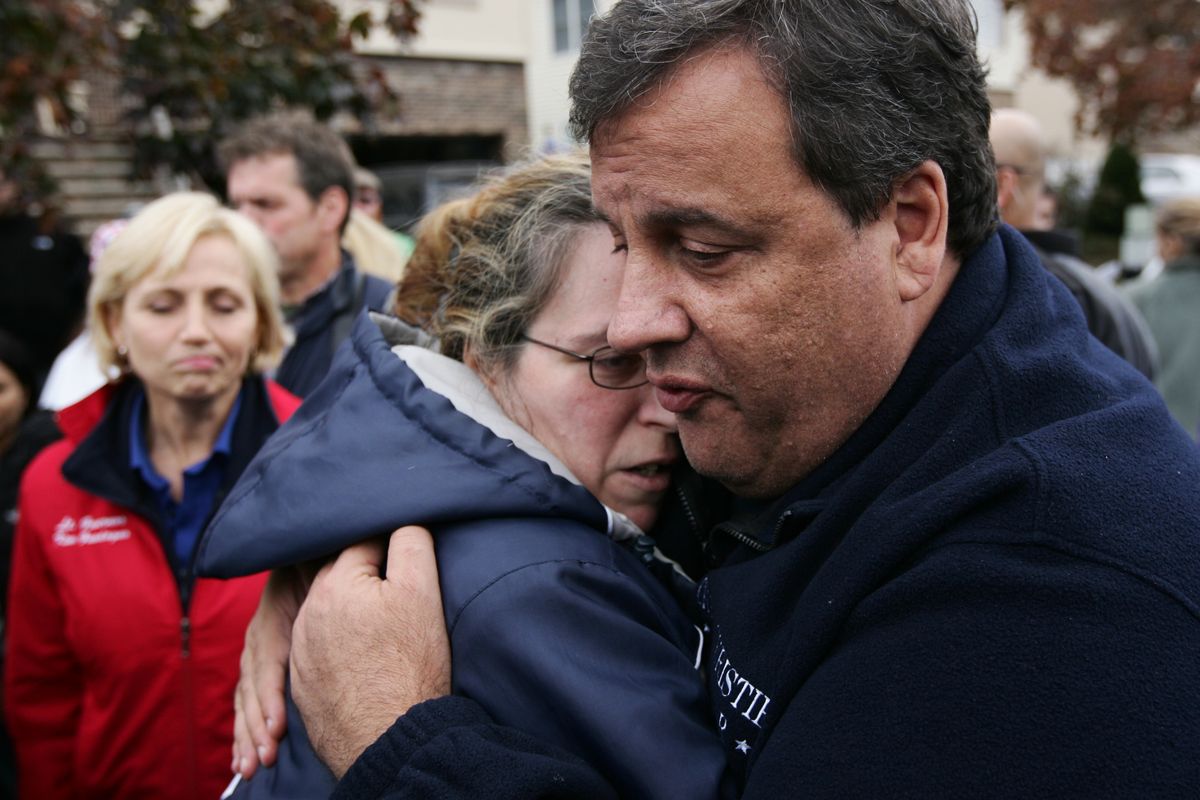 New Jersey Gov. Chris Christie tries to comfort Alice Cimillo and other Moonachie, N.J. residents whose homes were damaged by Superstorm Sandy, Thursday, Nov. 1, 2012, during a tour of the flood-ravaged area. The flooding of Moonachie, Little Ferry and Carlstadt, three communities sandwiched between Teterboro Airport, MetLife Stadium and the Hackensack River, was caused by six dirt berms that broke from the pressure of a tidal surge, Christie said. More than 1.7 million customers in New Jersey remain without power _ down from over 2.7 million at the height of the outages. (Kevin Wexler / Pool The Record Of Bergen County)