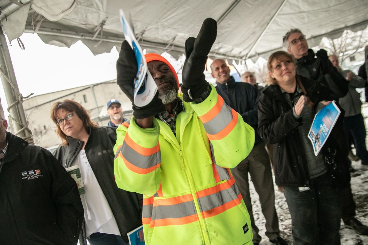 Warren Polk claps with other attendees during the official groundbreaking ceremony for the new $53 million Spokane Sportsplex on a brisk Wednesday. The 135,00 square foot sports complex, which is projected to open in fall 2021, is located on Dean Avenue across from Spokane Veterans Memorial Arena. (Libby Kamrowski / The Spokesman-Review)