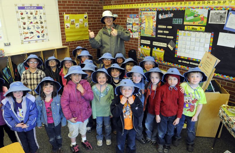 Teacher Bob McCaslin and his CV Kindergarten Center class show the hats they can wear during school recess, provided to them by doctors and staff from Advanced Dermatology, who came to the school May 3 to teach skin and sun safety. (J. Bart Rayniak)