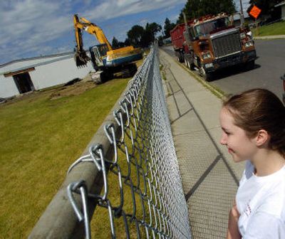 
Stephanie Richling, 18, brought her camera to Ridgeview Elementary School to take photos as it was being demolished Monday. Stephanie, her mother and other family members attended the school.
 (Christopher Anderson/ / The Spokesman-Review)