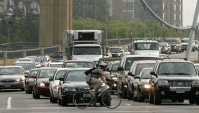 
A bicyclist passes by heavier than usual traffic coming into Minneapolis on the Hennepin Avenue bridge during the morning rush hour Monday,  in Minneapolis. Associated Press
 (Associated Press / The Spokesman-Review)