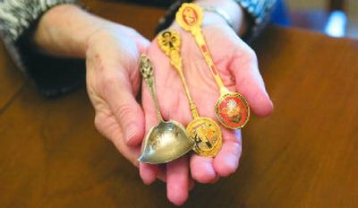 
Charlotte Peterson has a collection of souvenir spoons from the United States and parts of the world. She holds a spoon, left, that she believes dates from the opening of Yellowstone Park. The middle spoon is from Egypt and the spoon on the right is from Singapore. 
 (Christopher Anderson/The Spokesman-review / The Spokesman-Review)