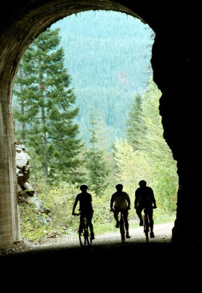 
Cyclists enter the Hiawatha's St. Paul Pass Tunnel. Helmets and lights are required to ride the 15-mile rail-trail near Lookout Pass.
 (File photos/ / The Spokesman-Review)
