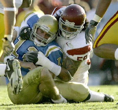 
Southern Cal's Rey Maualuga, right, tackles UCLA quarterback Patrick Cowan, left, for a loss. 
 (Associated Press / The Spokesman-Review)