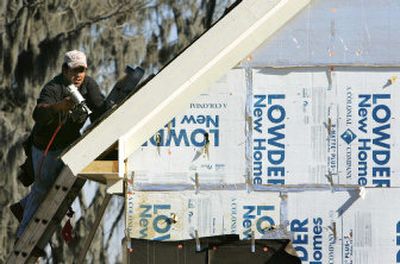 
A worker put shingles on a home under construction Friday in Montgomery, Ala. The median price of a new home sold was $225,200 last month. 
 (Associated Press / The Spokesman-Review)