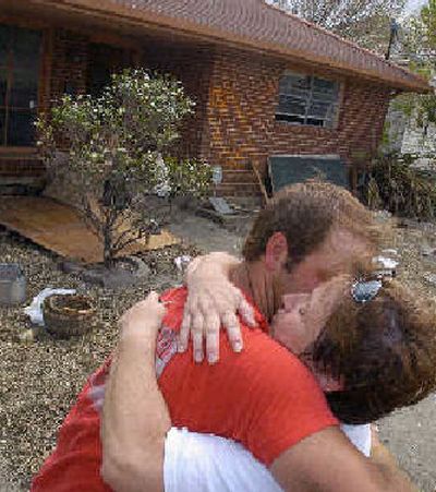 
Theresa Heller hugs her son Christopher on Saturday as members of their family finish salvaging things from her parents' home in Arabi, La. 
 (Associated Press / The Spokesman-Review)