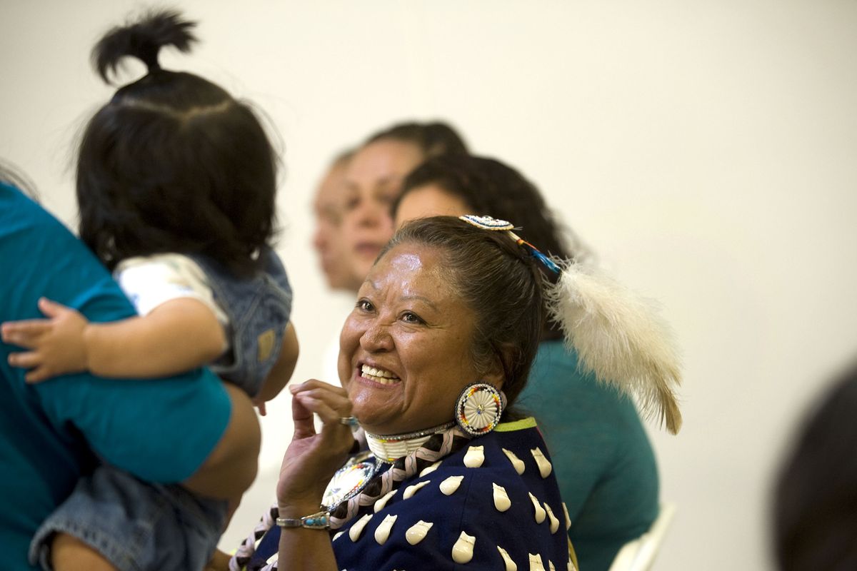 Kootenai tribal elder and tribal council member Velma Bahe shares a smile with 6-month-old Felix Shottanana, who is held by his mother Tracy, during the opening celebration of the Twin Rivers Hatchery for sturgeon and burbot in Moyie Springs, Idaho, on Thursday. (Kathy Plonka)