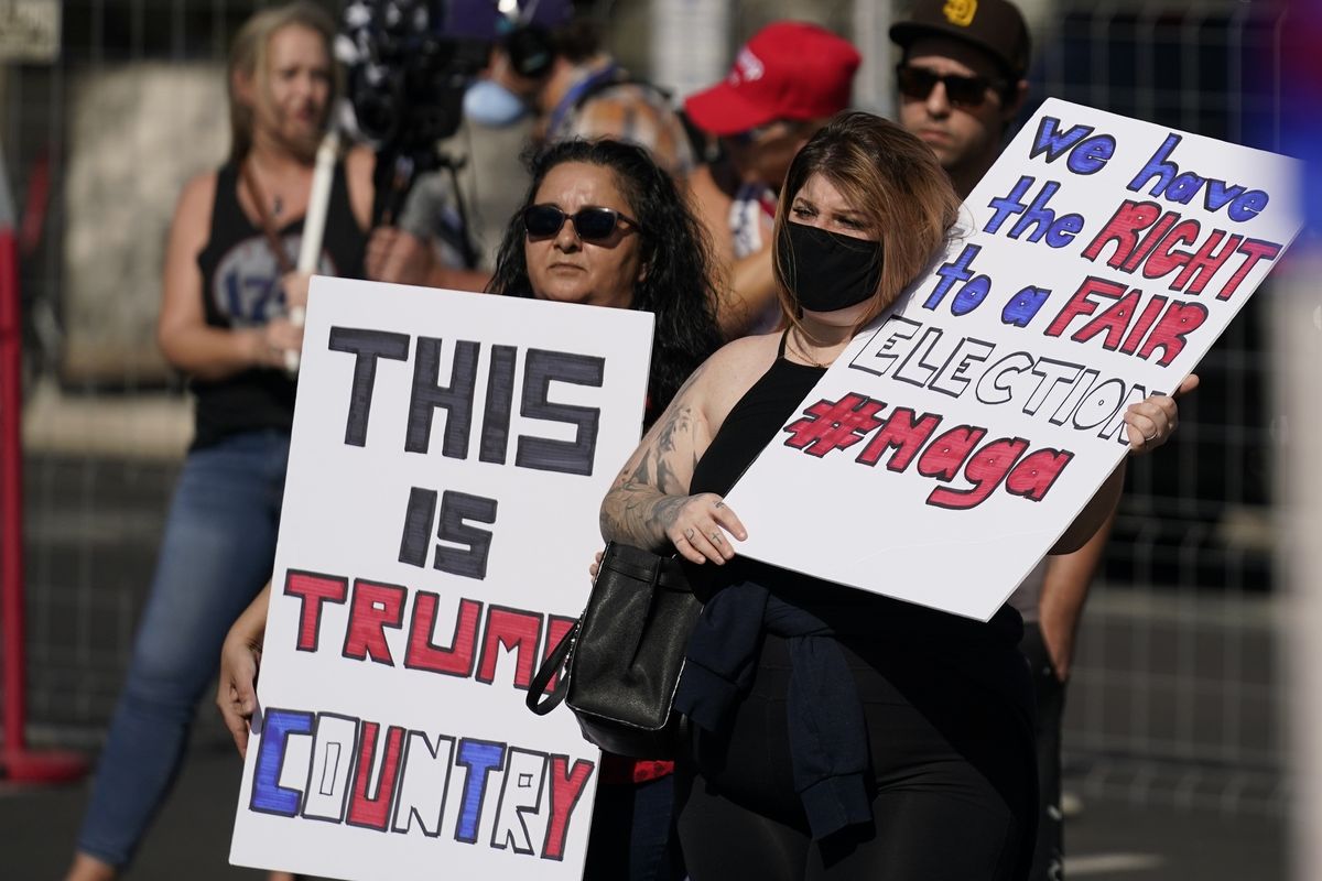 In this Saturday, Nov. 7, 2020 photo, supporters of President Donald Trump rally outside the Maricopa County Recorder's Office in Phoenix. Supporters of former President Donald Trump who were hired to review the 2020 vote count in Arizona's largest county are preparing to deliver their report to state Republicans on Monday, though their findings won't immediately be made public.  (Ross D. Franklin)