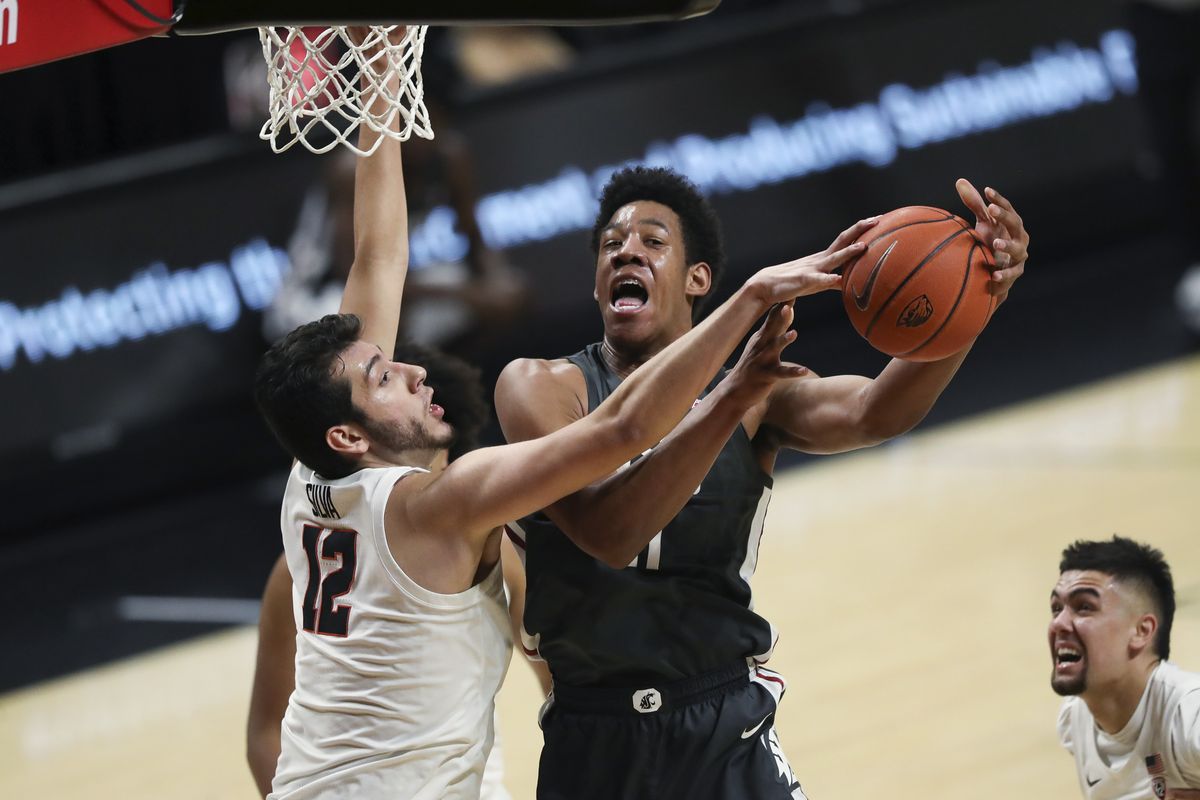 Oregon State’s Roman Silva blocks a shot by Washington State’s Dishon Jackson during the first half of Saturday’s Pac-12 Conference game in Corvallis, Ore.  (Theo Lawson / The Spokesman-Review)