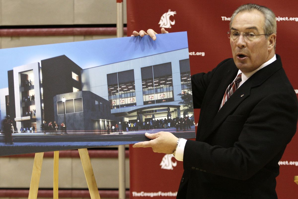 LEFT: In this Aug. 15 photo, workers erect a new scoreboard on the east end of Martin Stadium at Washington State University in Pullman. The scoreboard will replace one on the east end of the stadium that was removed to make way for the Football Operations Center. ABOVE: Washington State athletic director Bill Moos shows an architect’s rendering of the $80 million Martin Stadium remodeling project the WSU Board of Regents approved on Nov. 18, 2011 (Associated Press)