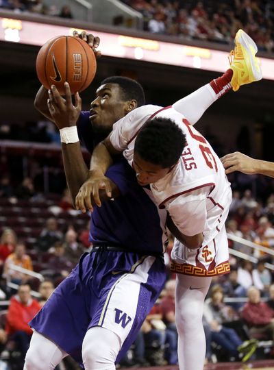 UW’s Mike Anderson, left, shoots under duress. (Associated Press)