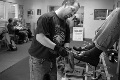 
Alex Baker prepares to shine a customer's shoes at Gentle Touch car wash. 
 (Holly Pickett / The Spokesman-Review)