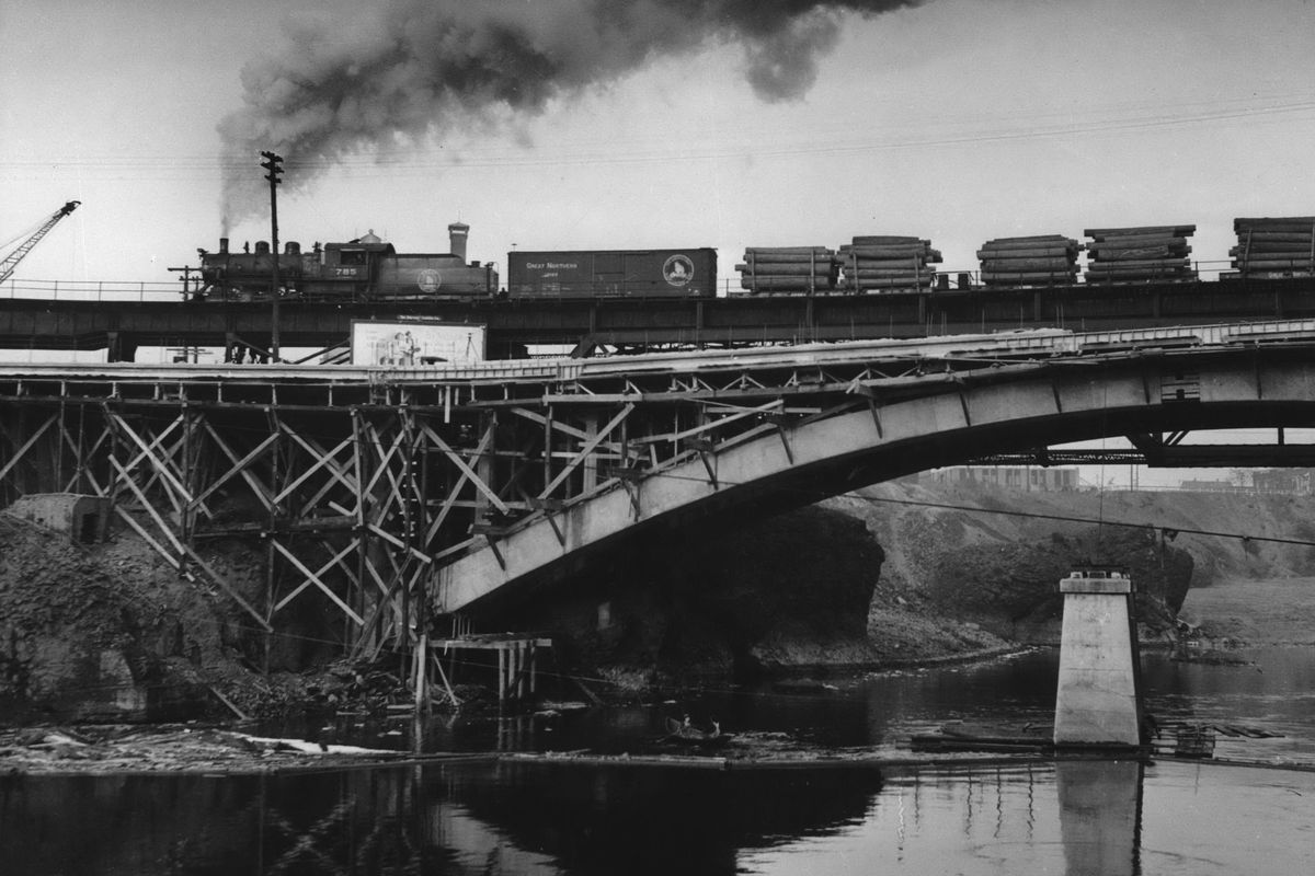 1936 – A Great Northern steam engine pulls a load of logs, likely cut in the forests of Idaho, through downtown Spokane and over the Post Street Bridge, which was being widened in December 1936. The Great Northern Railway was built in part by James J. Hill, one of the great rail barons of the late 1800s, who built one of the transcontinental railroads through Spokane and added a giant rail yard and repair complex in Hillyard. Jesse Tinsley/THE SPOKESMAN-REVIEW (Jesse Tinsley / The Spokesman-Review)
