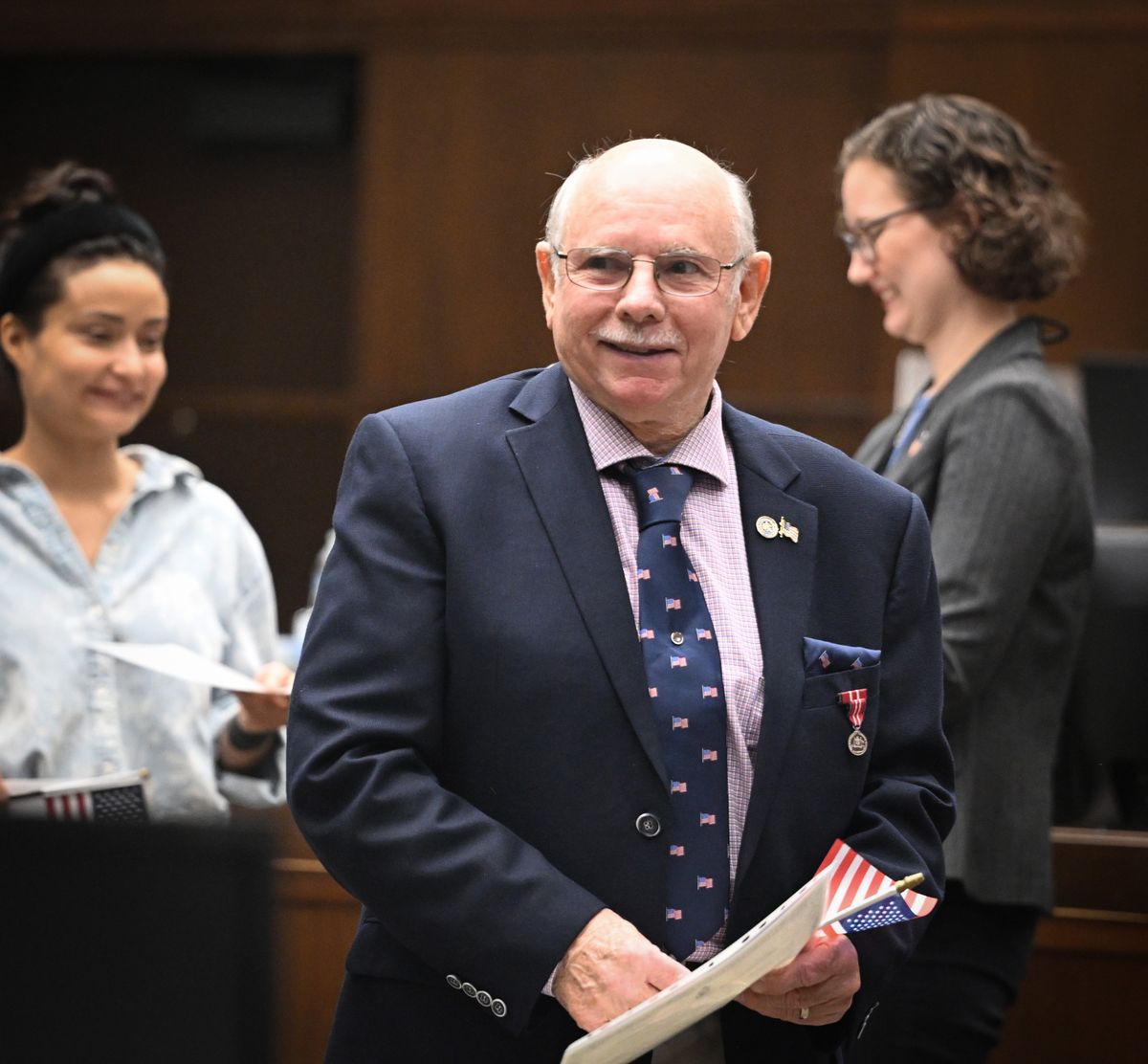 Eric Lee, an Australian citizen, smiles after receiving his naturalization certificate Aug. 13 at the Thomas S. Foley Federal Courthouse after taking the oath of citizenship. Lee was in the Australian navy in the Vietnam era and survived the collision of the USS Frank E. Evans, a U.S. destroyer, and the HMAS Melbourne, a Royal Australian Navy aircraft carrier. Seventy-four men on the Evans were killed.  (Jesse Tinsley/THE SPOKESMAN-REVIEW)