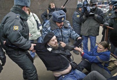 
Russian police work to detain environmental protesters near the lower parliament house in Moscow on Wednesday. Russian lawmakers were voting on a controversial bill putting new restrictions on non-governmental organizations. 
 (Associated Press / The Spokesman-Review)