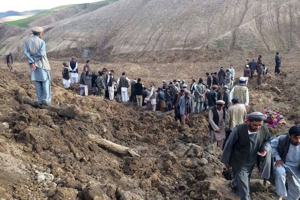 Afghans search for survivors after a massive landslide buried a village Friday in Badakhshan province, near the China border. (Associated Press)