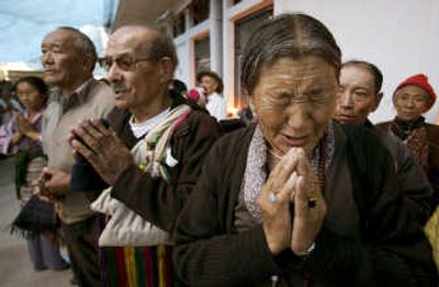 
Tibetans sing their national anthem  at a candlelight vigil to protest China's crackdown on Tibetan protesters, at a prayer meeting in Katmandu, Nepal, on Wednesday. Associated Press
 (Associated Press / The Spokesman-Review)