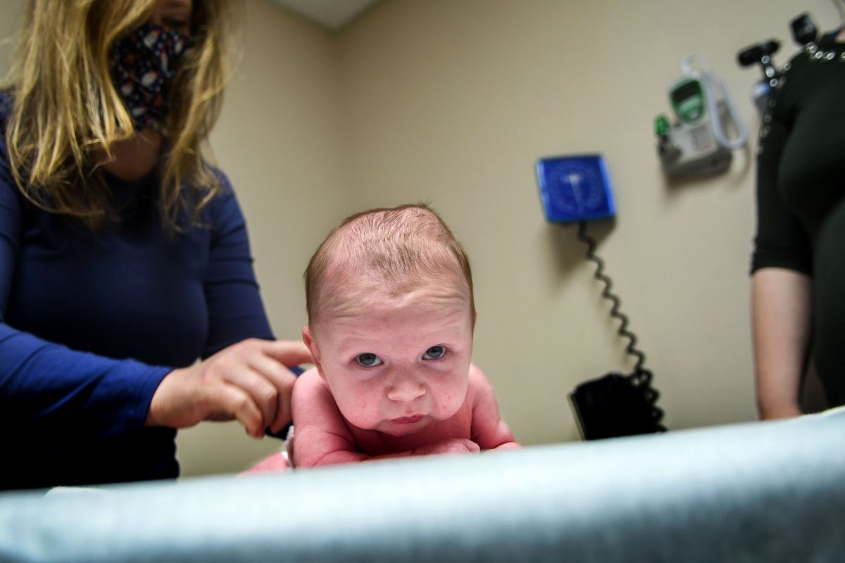 Nineteen-day-old Derek Bourne is examined by pediatrician Dr. Nicole Odom in Kellogg on Thursday.  (kathy plonka)