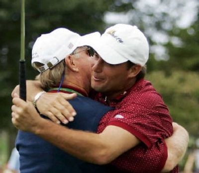 
Chris DiMarco, right, hugs captain Jack Nicklaus after DiMarco's win over Stuart Appleby gave the U.S. the Presidents Cup. 
 (Associated Press / The Spokesman-Review)