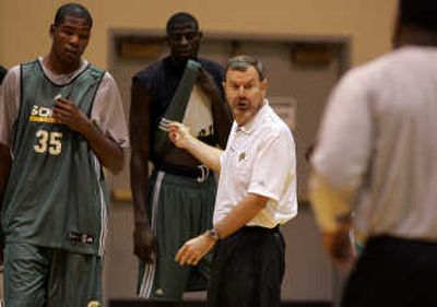 
Sonics coach P.J. Carlesimo, right, gives instructions to players Kevin Durant, left, and, Mouhamed Sene.Associated Press
 (Associated Press / The Spokesman-Review)
